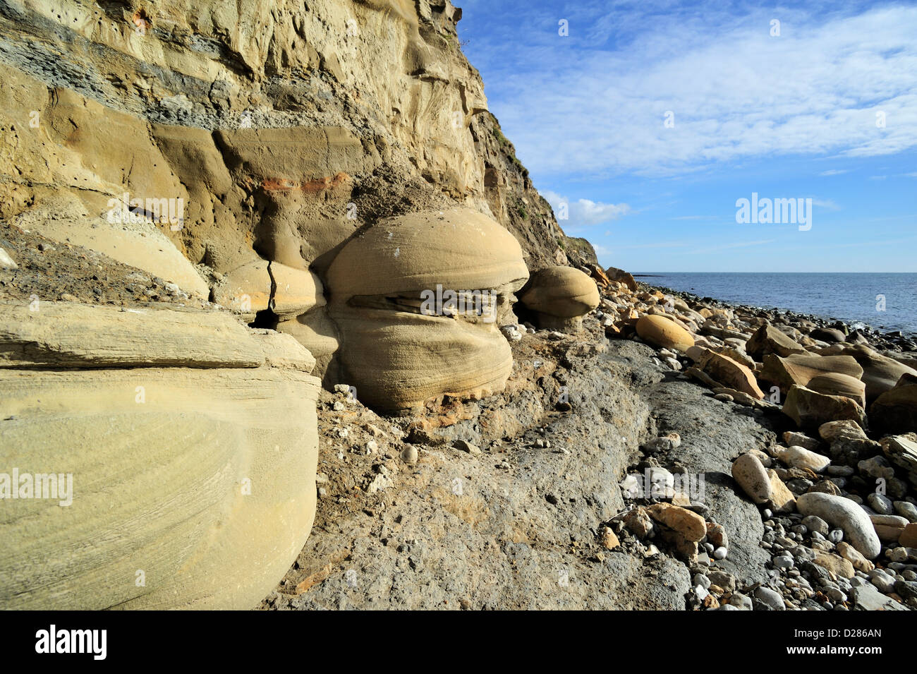 Rounded nodules on beach at Osmington Mills come from the Bencliff Grit Formation, Jurassic Coast, Dorset, southern England, UK Stock Photo