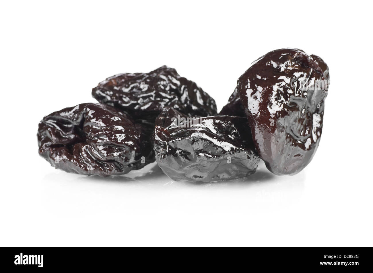 Dried prunes over a reflective white background Stock Photo Alamy