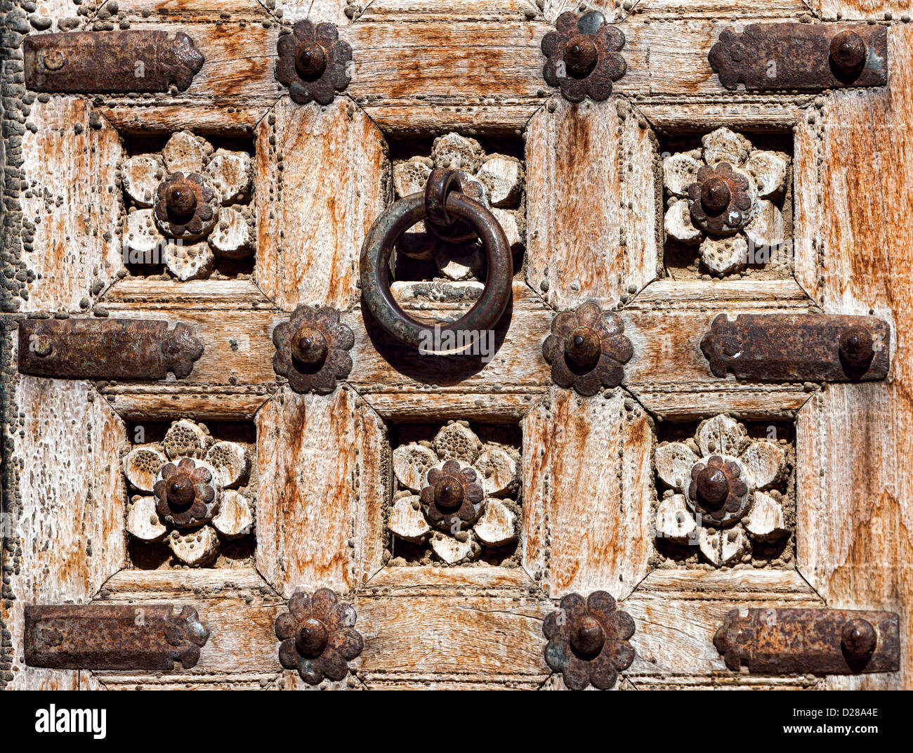 Old wooden door with floral decoration. Fragment. Rajasthan,India Stock Photo