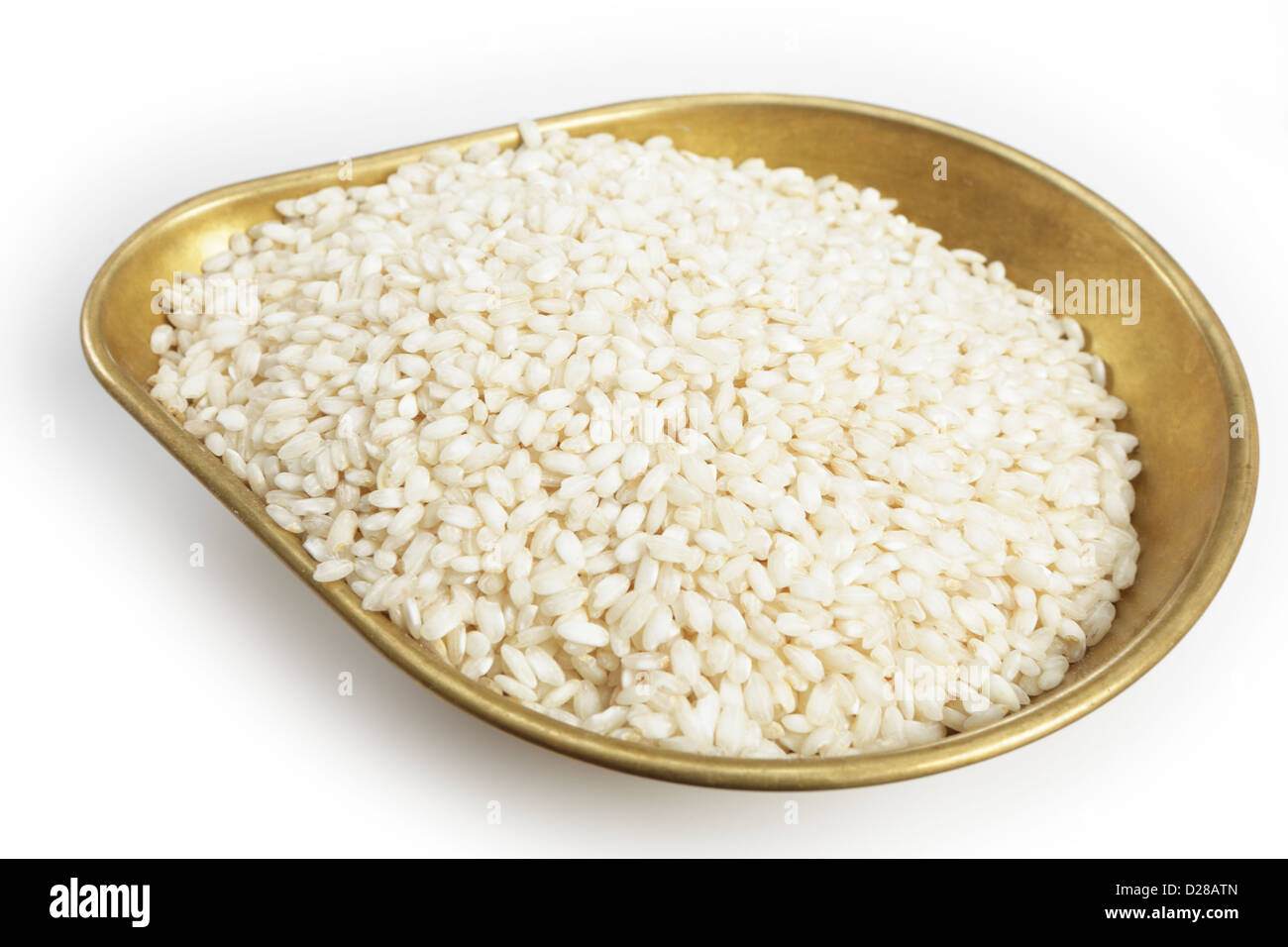A pile of 460grams (one pound) of arborio Italian rice in the weighing pan from a set of scales, with a light shadow over white. Stock Photo