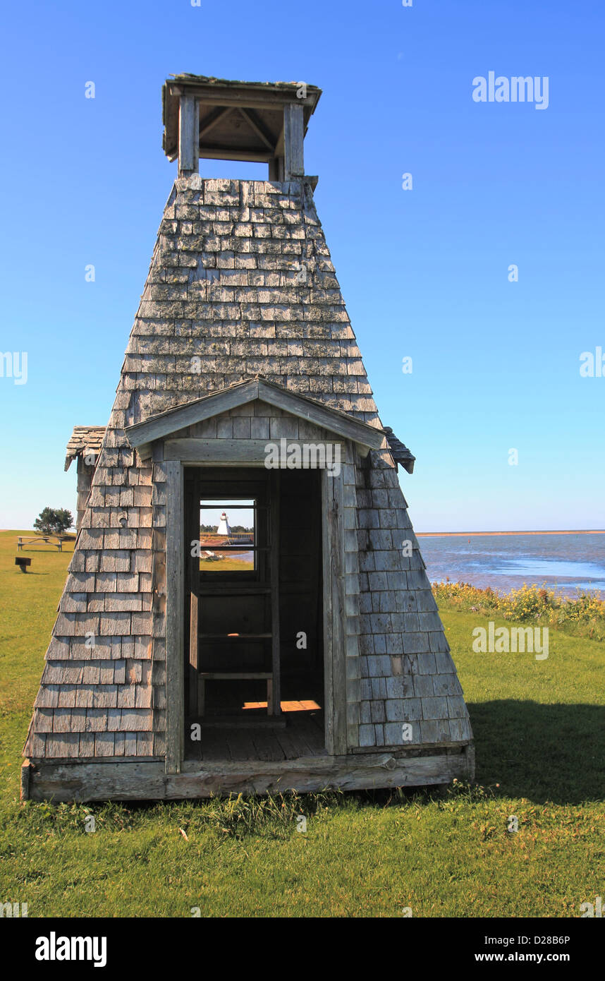 See the Lighthouse through playhouse, Woods Island, PEI, Canada Stock Photo