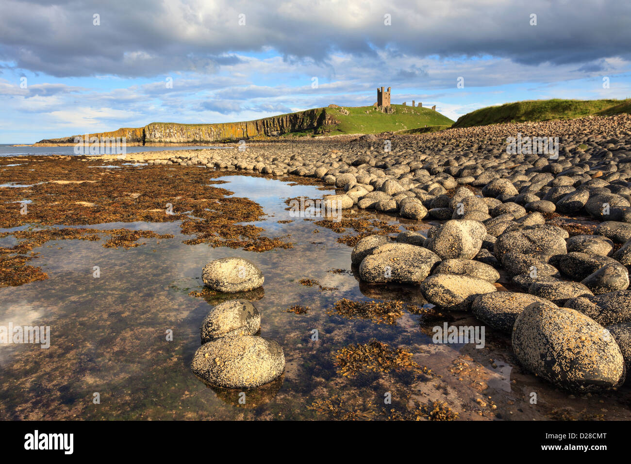 Dunstanburgh Castle captured from Greymare Rocks at the southern end of Embleton Bay in Northumberland.  The composition was car Stock Photo