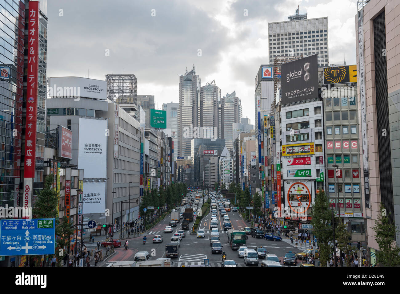 Busy Street Scene and Traffic in Shinjuku, Tokyo Japan Stock Photo