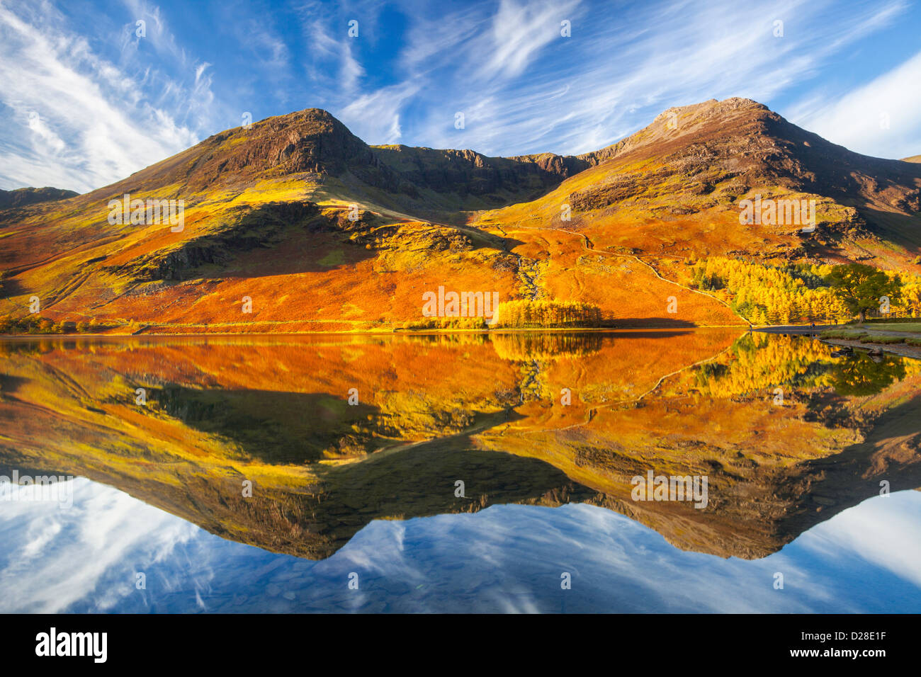 High Stile and High Crag reflected in Buttermere in the Lake District National Park.  Captured about an hour after sunrise on a Stock Photo