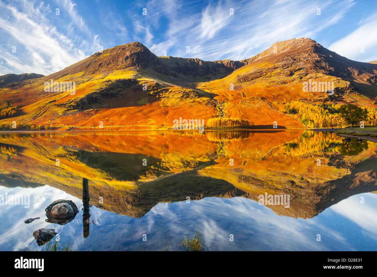 High Stile and High Crag reflected in Buttermere in the Lake District National Park.  Captured about an hour after sunrise Stock Photo