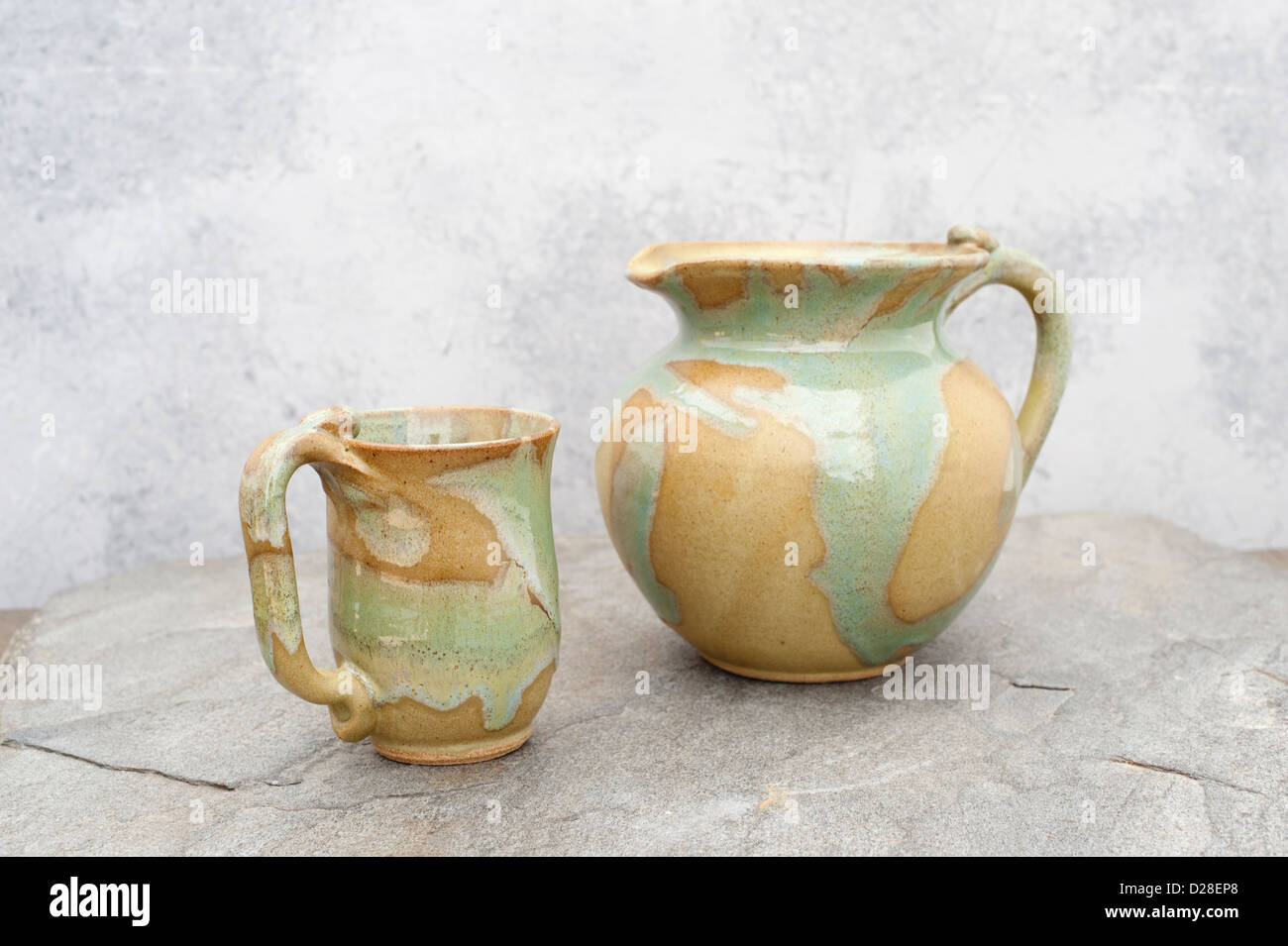 Still life photograph of a ceramic pitcher and cup. Stock Photo