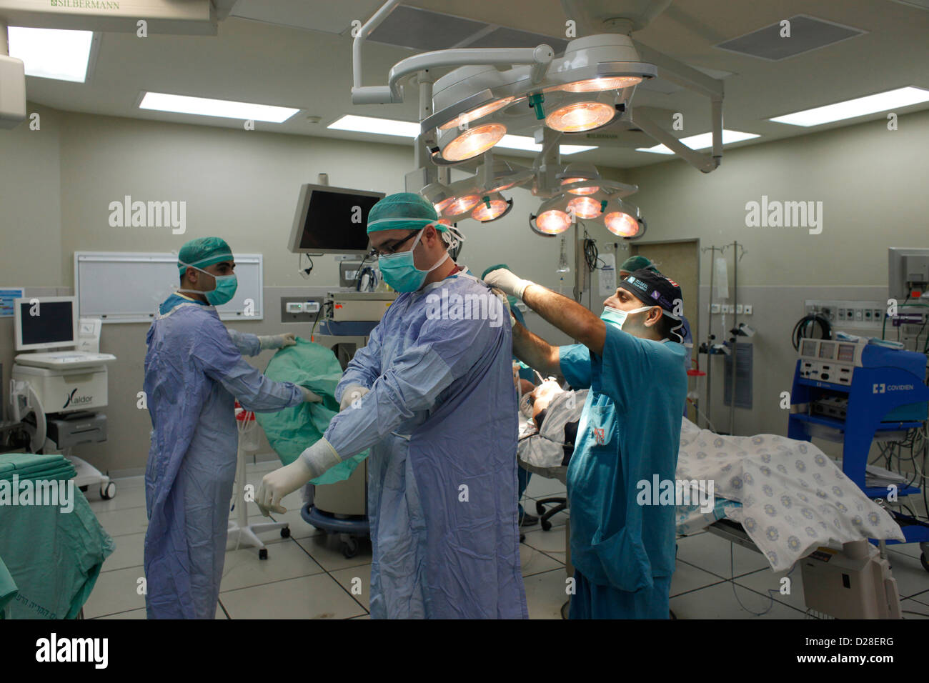 Surgeons wearing surgical mask preparing for operation in operating room in Rambam hospital