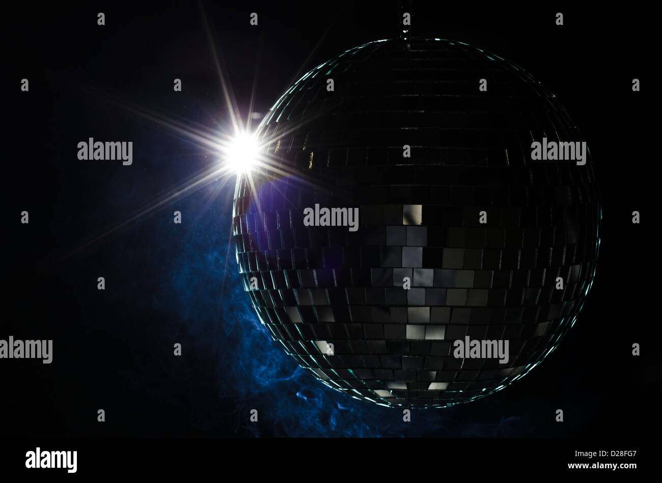 A disco ball with light flare and smoke. A nightlife image to be used as example on party fliers. Stock Photo