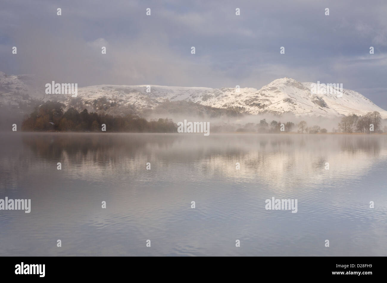 Helm Crag reflected in Grasmere in winter in the English Lake District Stock Photo