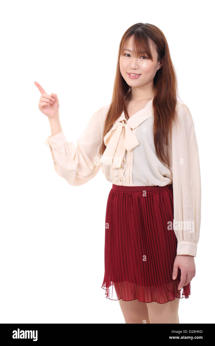Portrait of young asian woman pointing up Stock Photo
