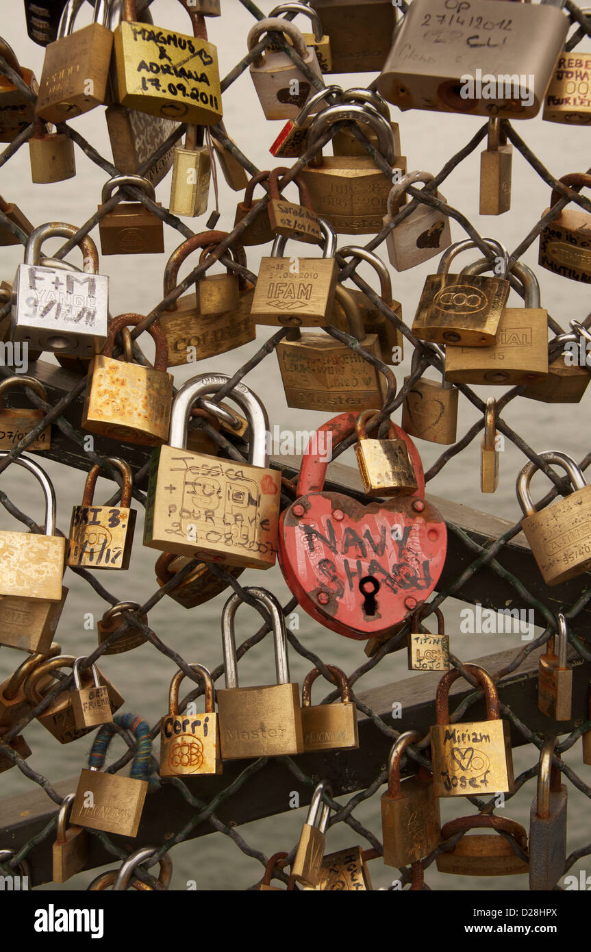 “Padlocks of love” attached to the Passerelle Pont des Arts, which bridges the River Seine in Paris. Sweethearts throw the key into the water. France. Stock Photo