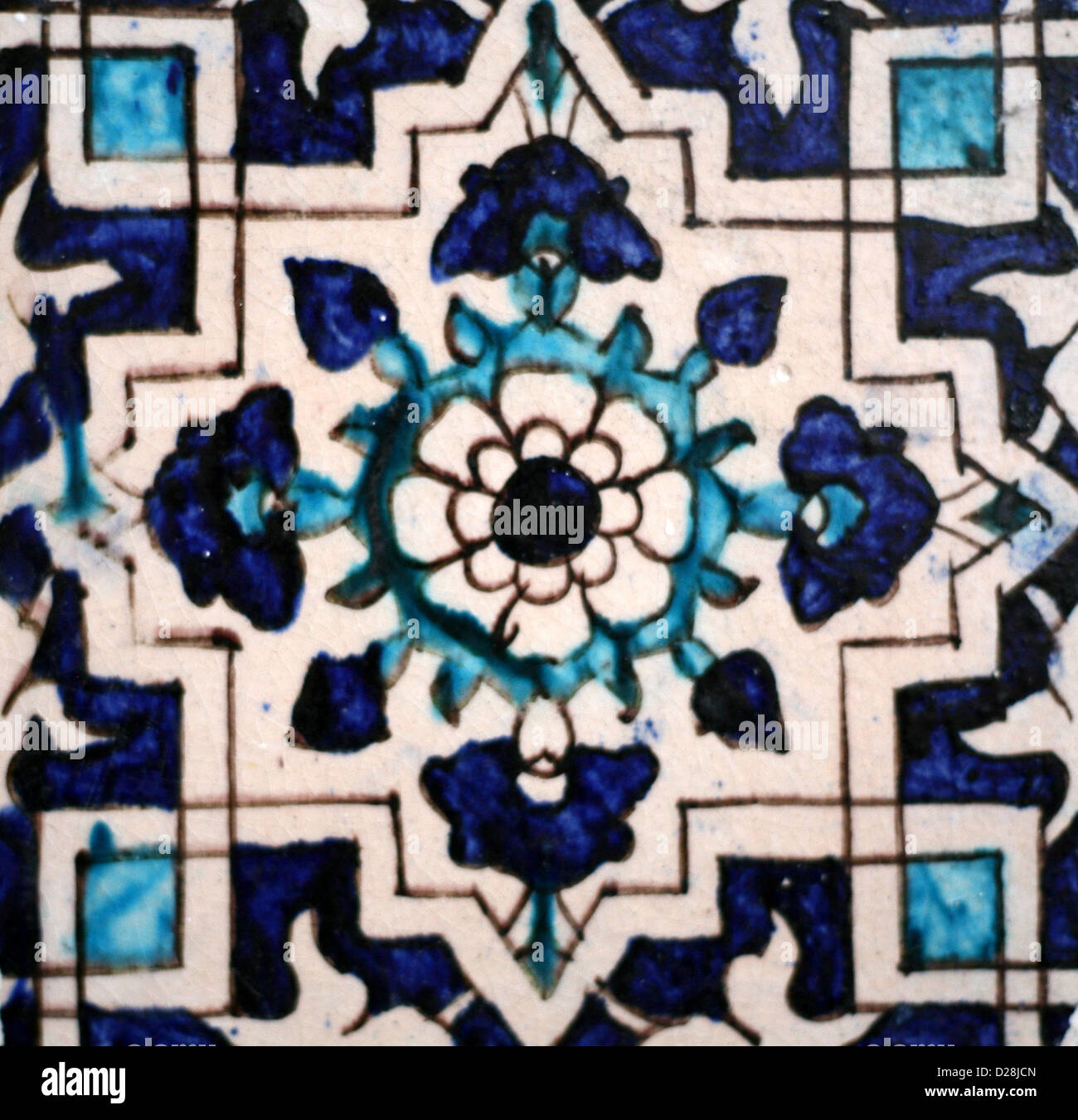 Old hand-painted geometric and floral patterned tile  made in Multan, Pakistan Stock Photo