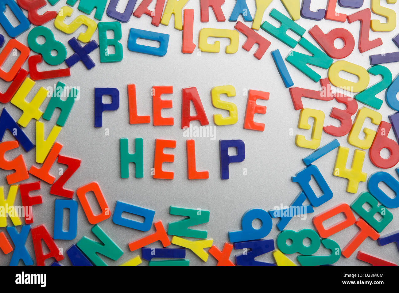 'Please Help' - Refrigerator magnets spell messages out of a jumble of letters Stock Photo