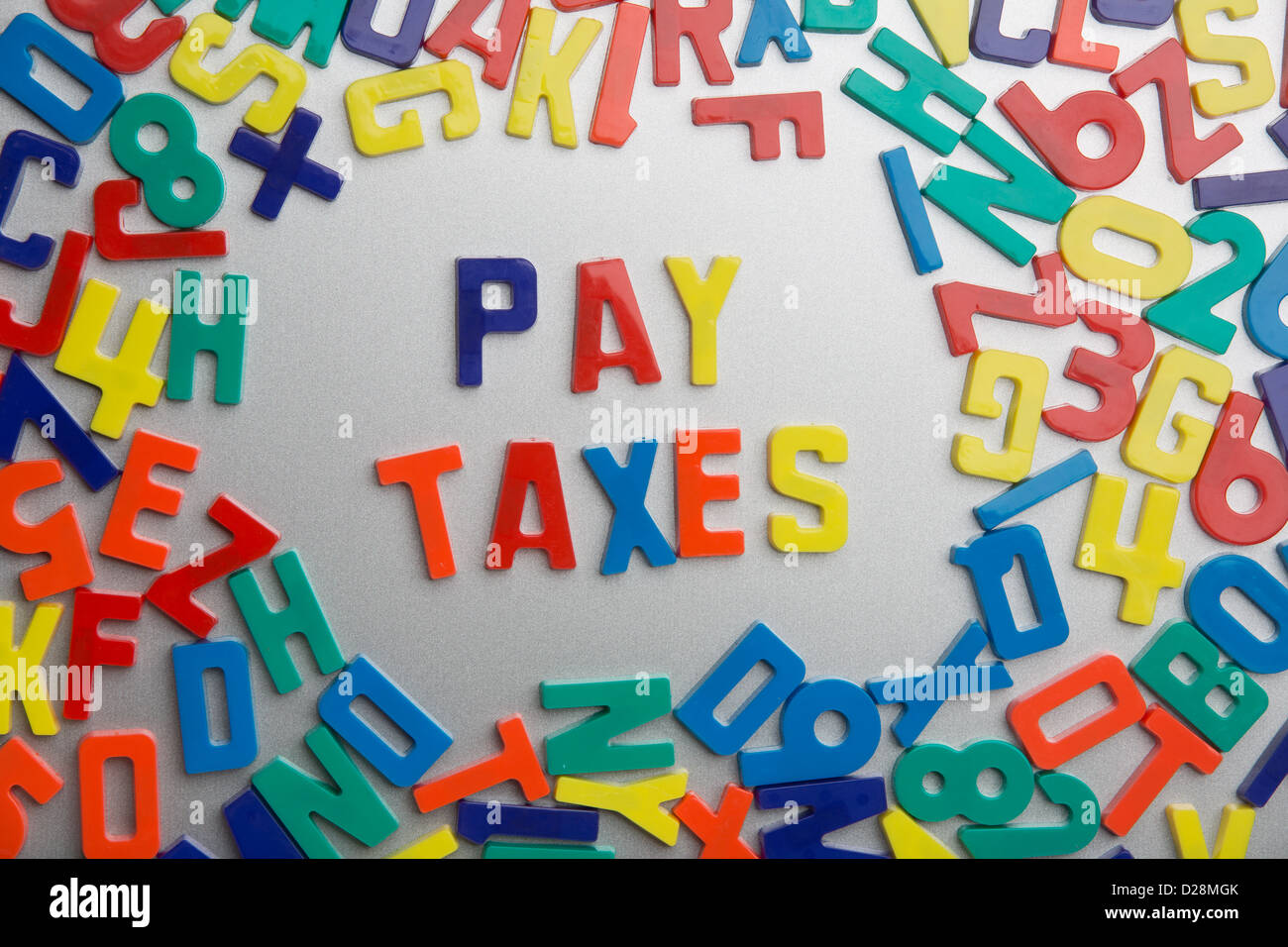 'Pay Taxes' - Refrigerator magnets spell messages out of a jumble of letters Stock Photo