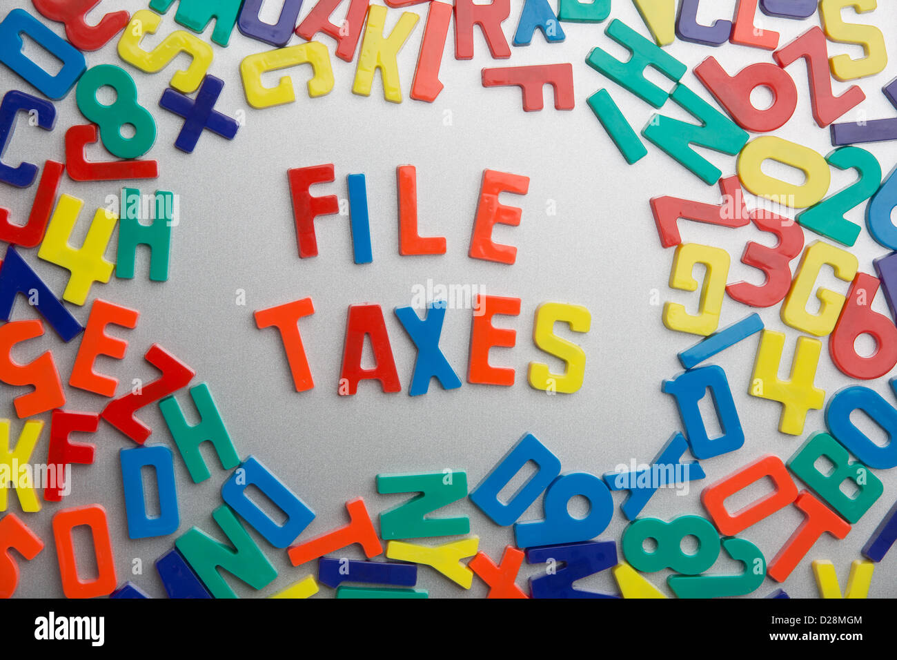 'File Taxes' - Refrigerator magnets spell a message out of a jumble of letters Stock Photo