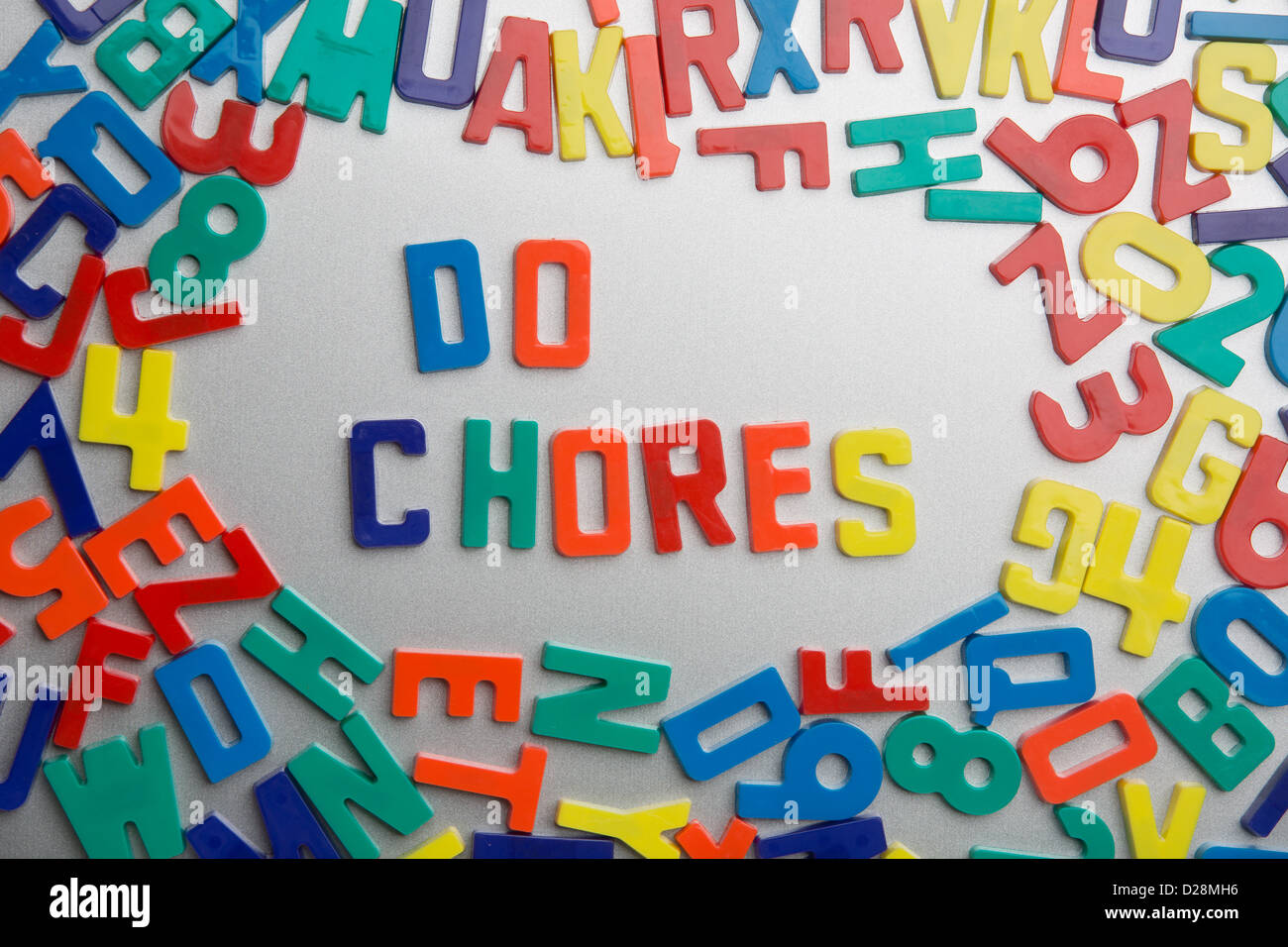 'Do Chores' - Refrigerator magnets spell messages out of a jumble of letters Stock Photo