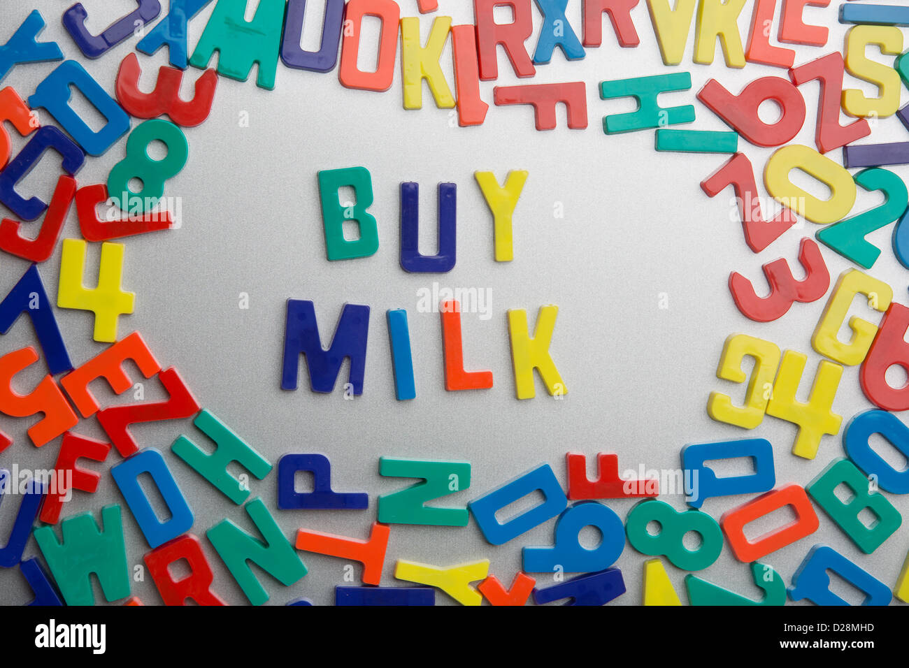 'Buy Milk' - Refrigerator magnet spells a message out of a jumble of letters Stock Photo