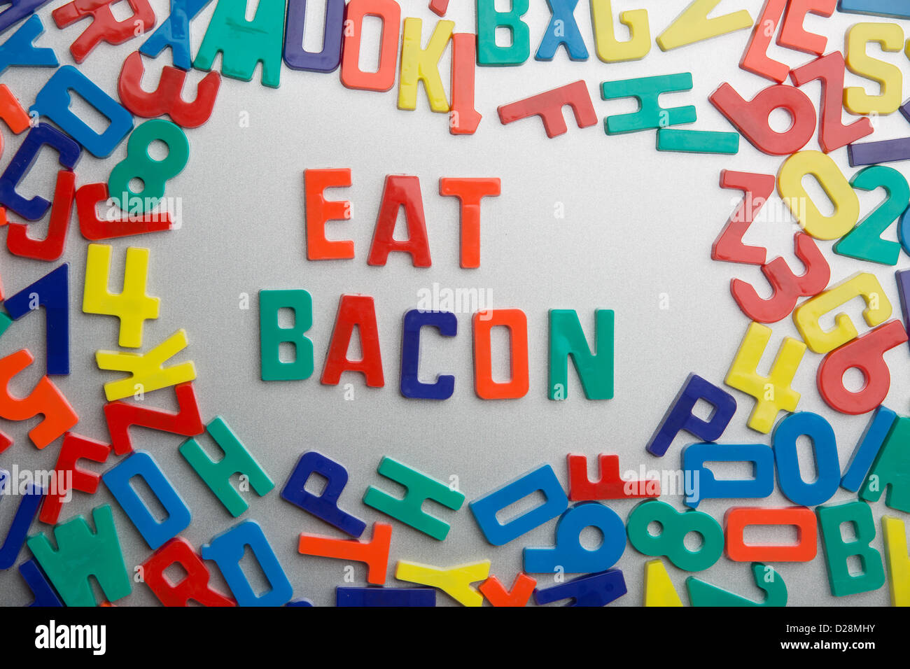 'Eat Bacon' - Refrigerator magnets spell a message out of a jumble of letters Stock Photo