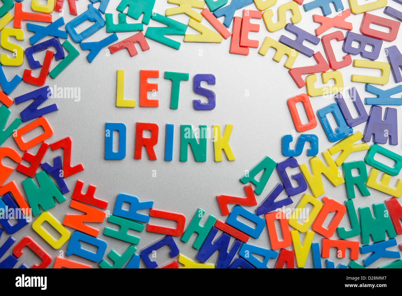 'Let's Drink' - Refrigerator magnets spell messages out of a jumble of letters Stock Photo