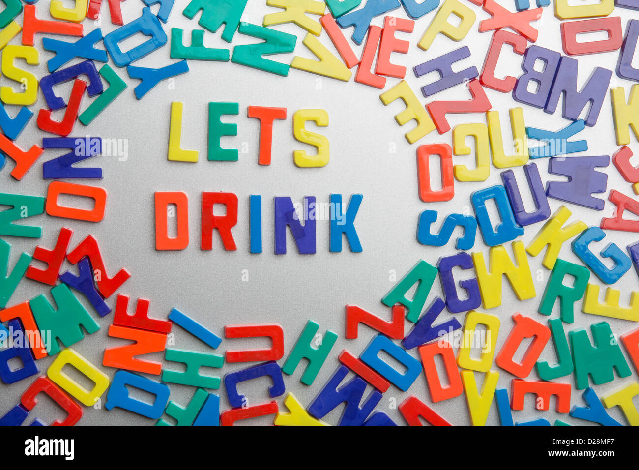 'Lets Drink' - Refrigerator magnets spell a message out of a jumble of letters Stock Photo