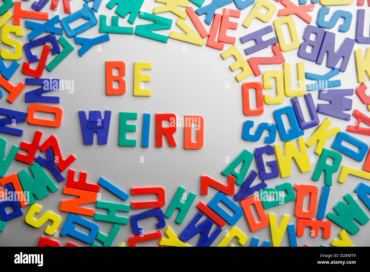 'Be Weird' - Refrigerator magnets spell a message out of a jumble of letters Stock Photo