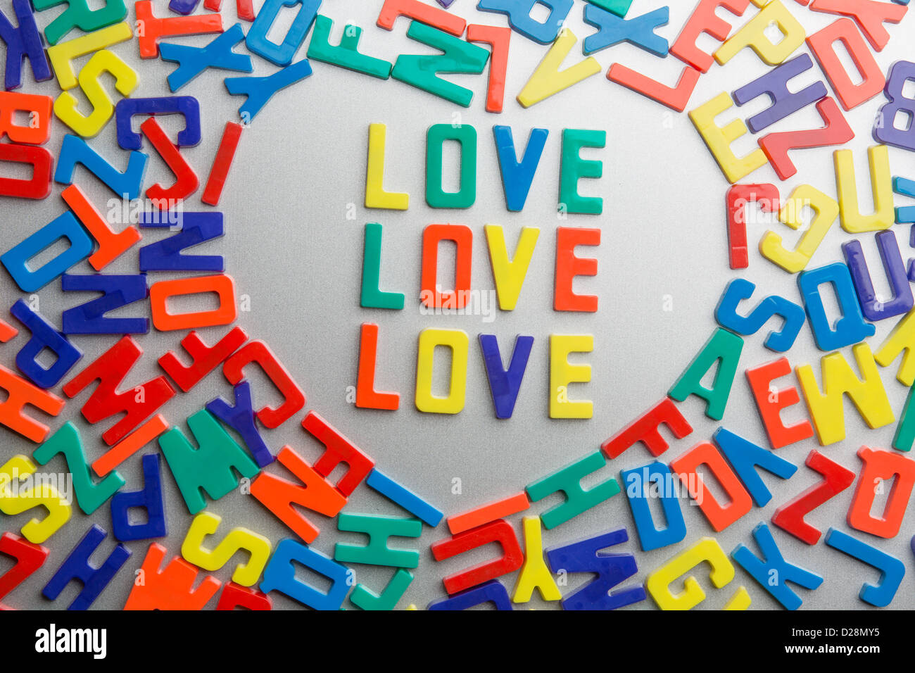'Love Love Love' - Refrigerator magnets spell a message out of a jumble of letters Stock Photo
