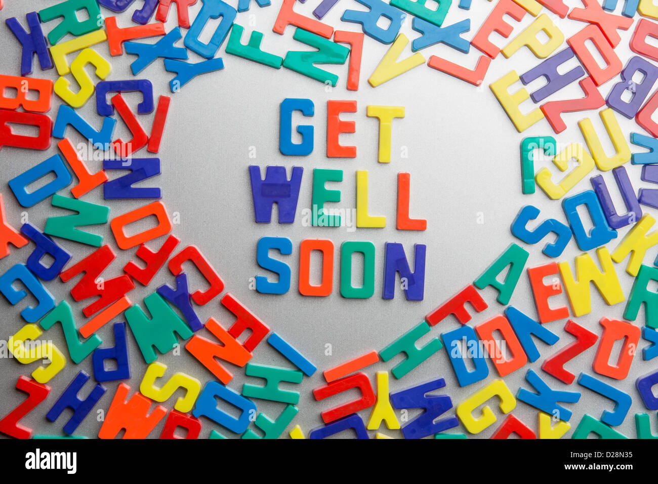 'Get Well Soon' - Refrigerator magnets spell a message out of a jumble of letters Stock Photo