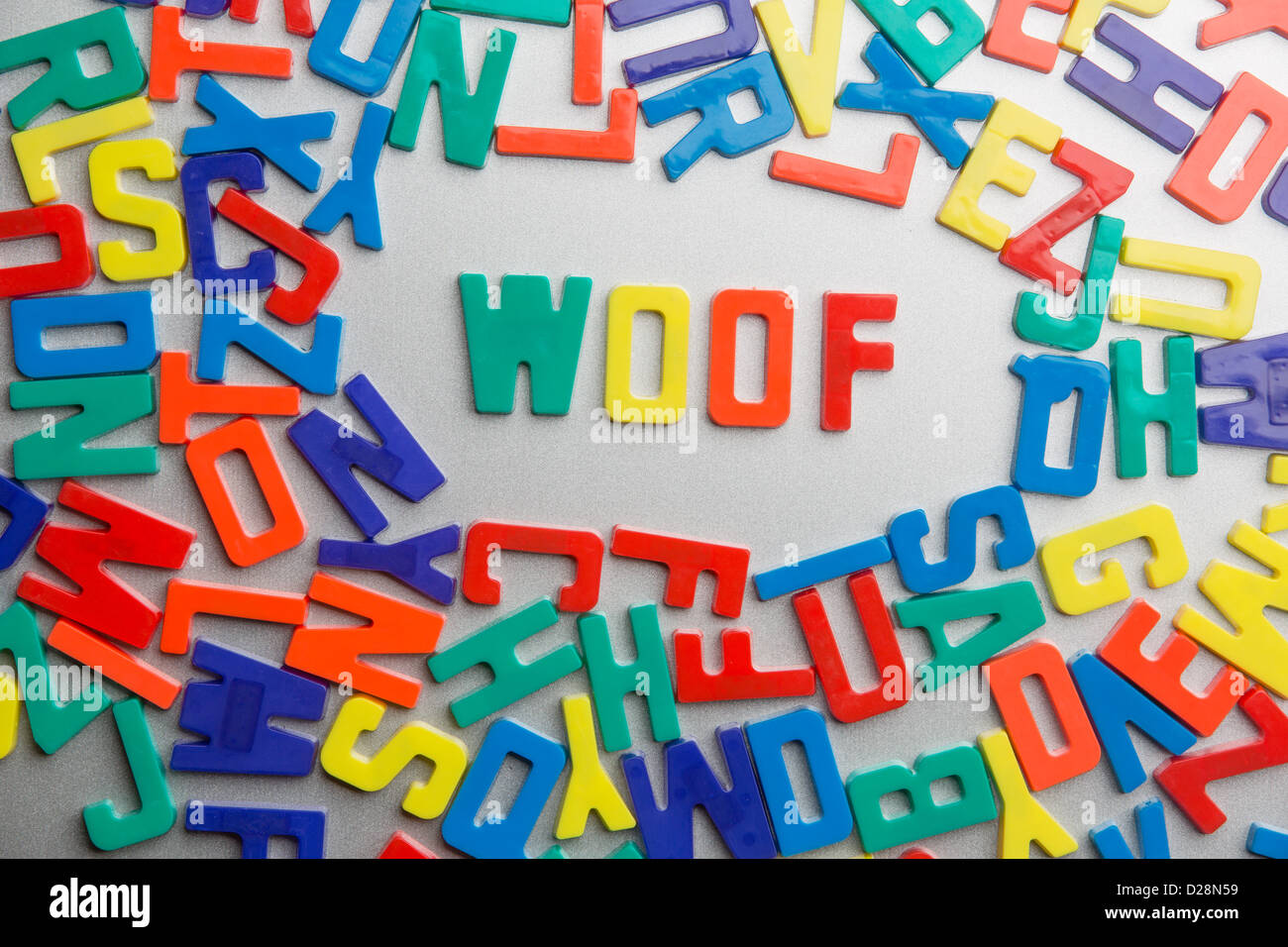 'woof' - Refrigerator magnets spell a message out of a jumble of letters Stock Photo