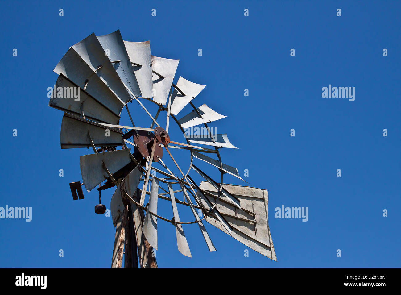 The metal windmill against a deep blue sky Stock Photo Alamy