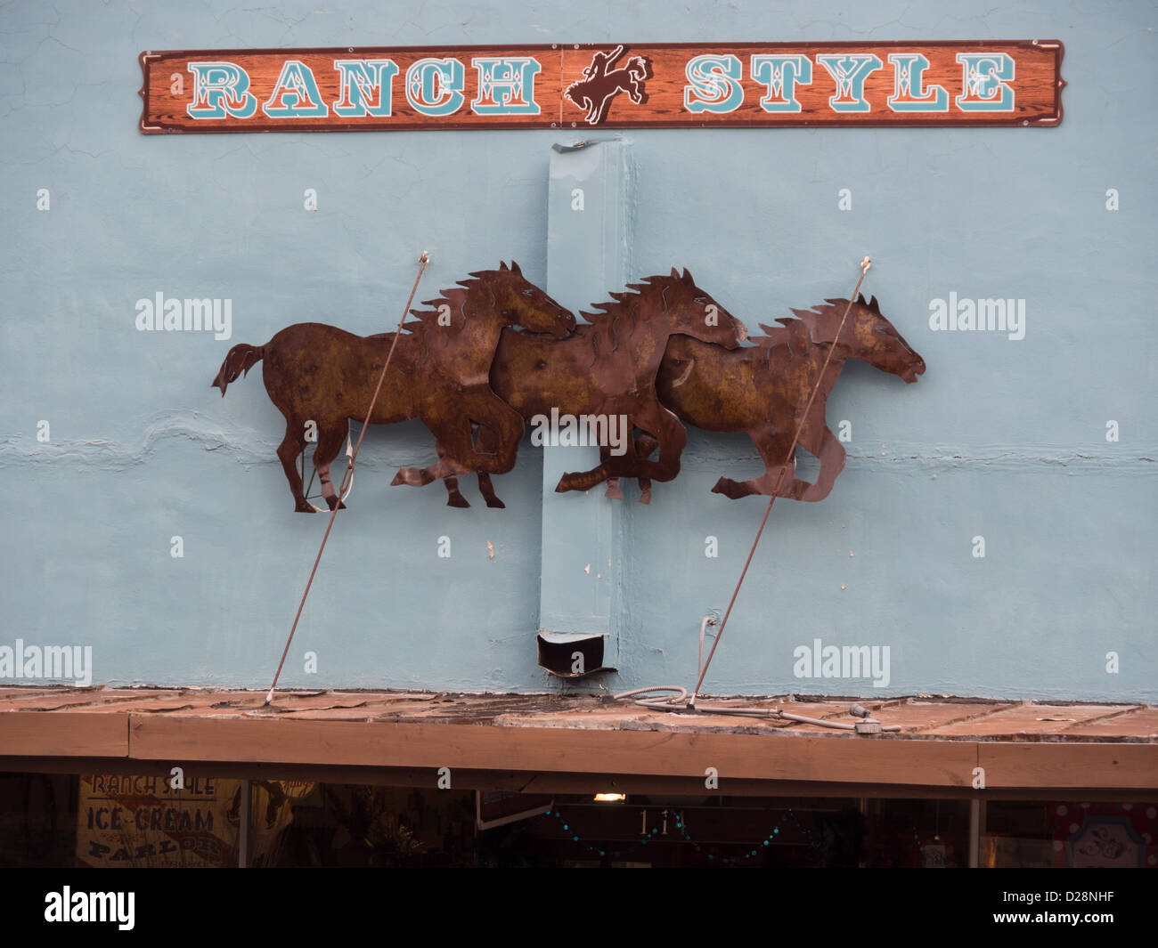 Cut metal sign of running wild horses on the Ranch Style store wall in Lockhart, Texas Stock Photo