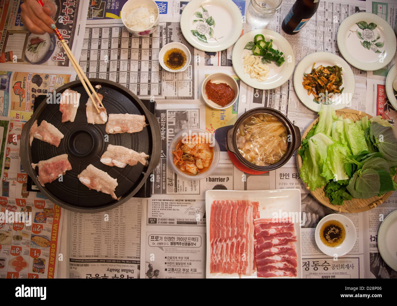 Home cooked Korean BBQ pork belly dinner on top of newspaper Stock Photo