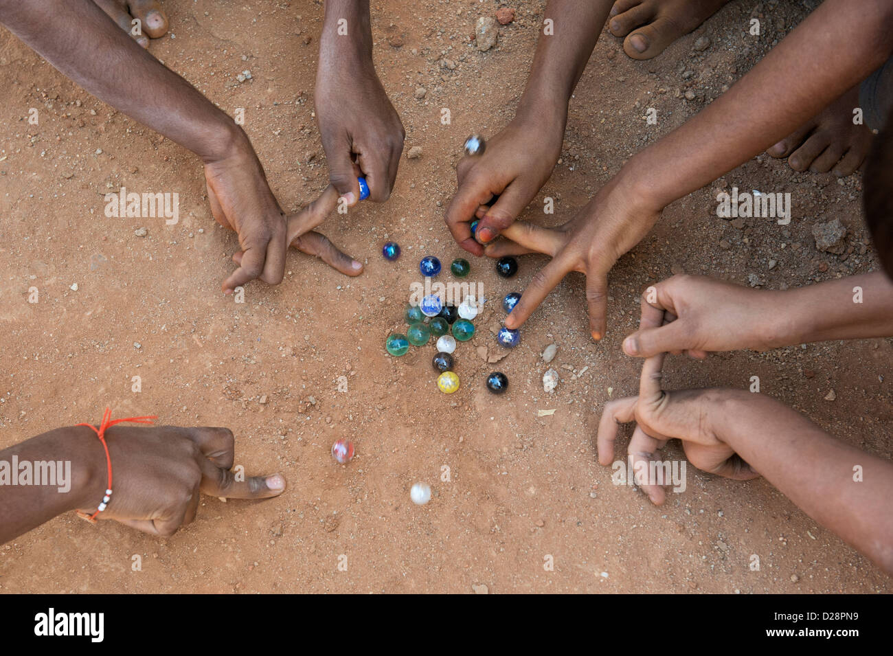 Indian boys playing marbles in a rural Indian village. Andhra Pradesh
