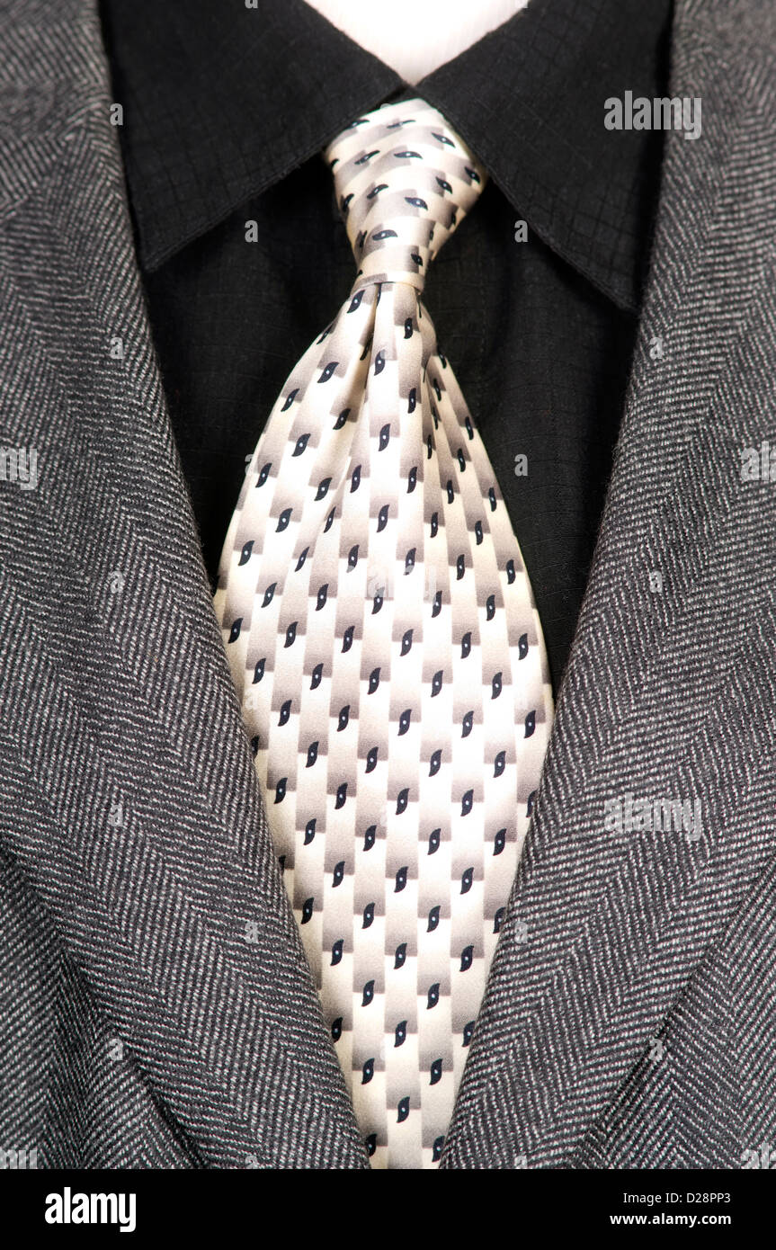 The theme is black and white for this men's ensemble outfit on a manikan Stock Photo