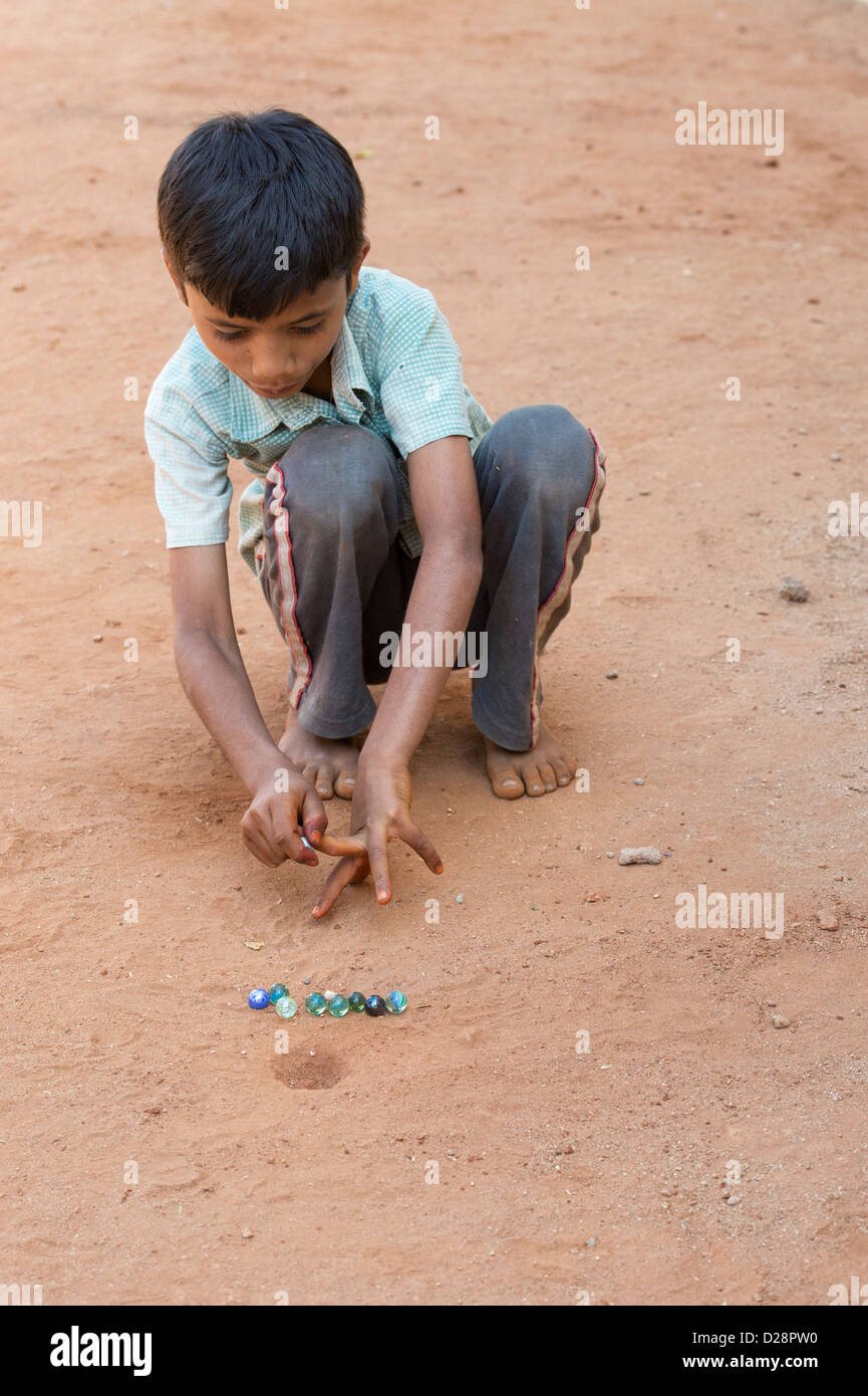 Indian boy playing marbles in a rural Indian village. Andhra Pradesh, India Stock Photo