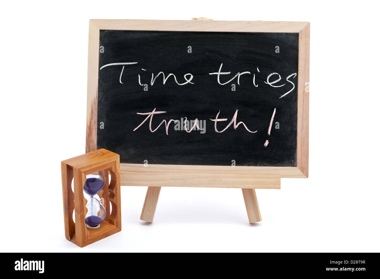 'Time tries truth' sayings written on chalkboard with an hourglass beside it Stock Photo