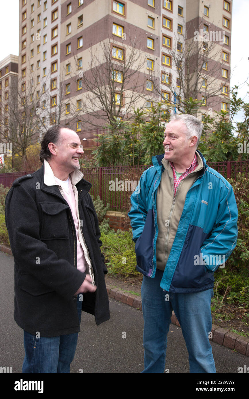 Tenant and housing officer in front of flats. Stock Photo