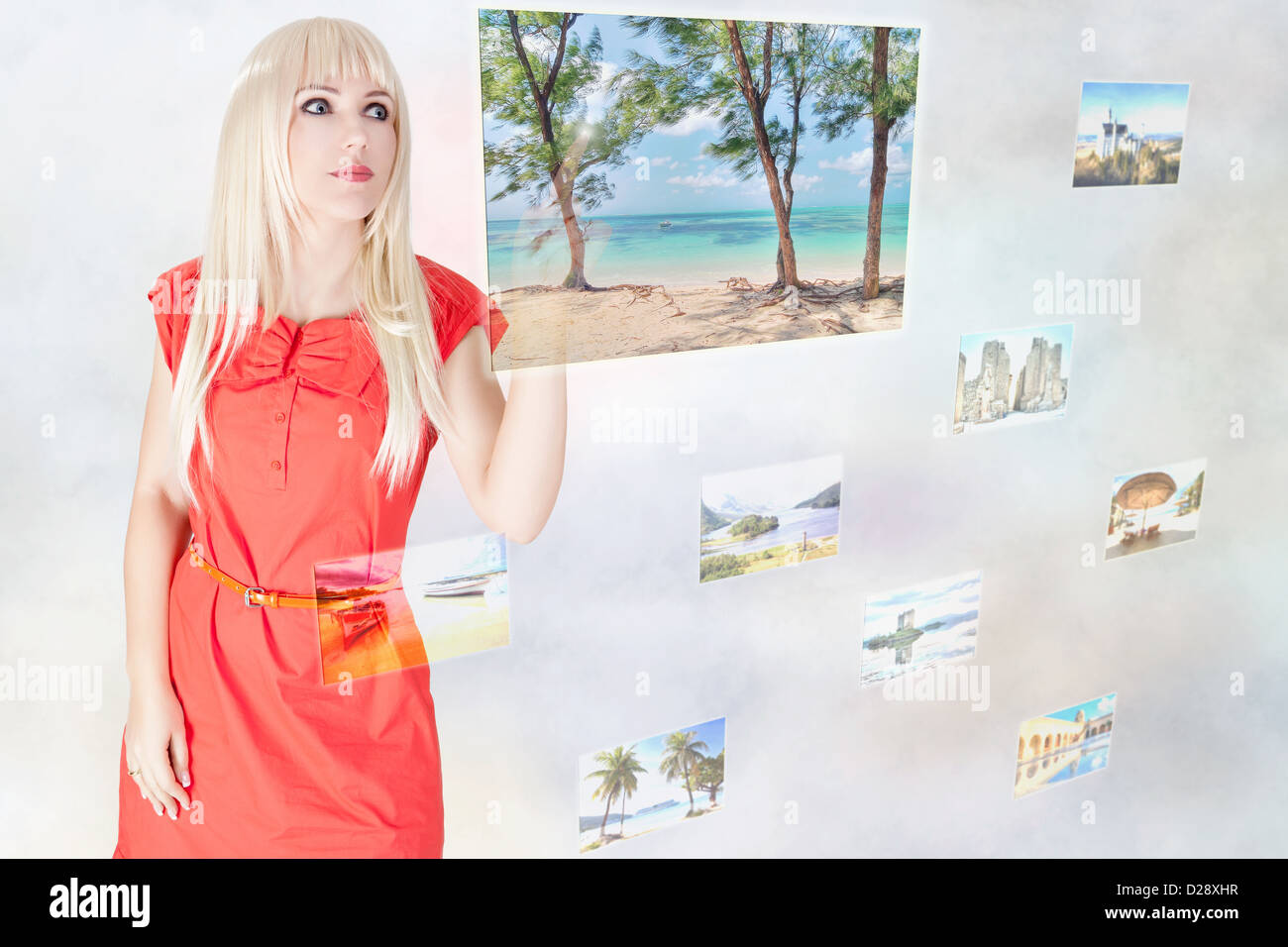 Woman choosing travel destination on modern touchscreen interface Stock Photo
