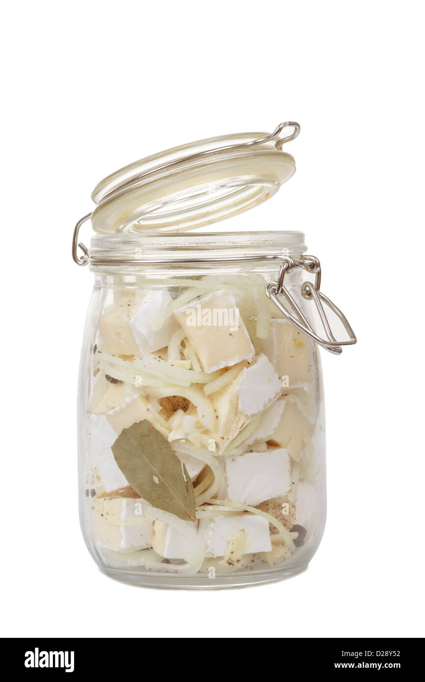 homemade spicy marinated cheese with oil, onion, garlic and spicy spices on white Stock Photo