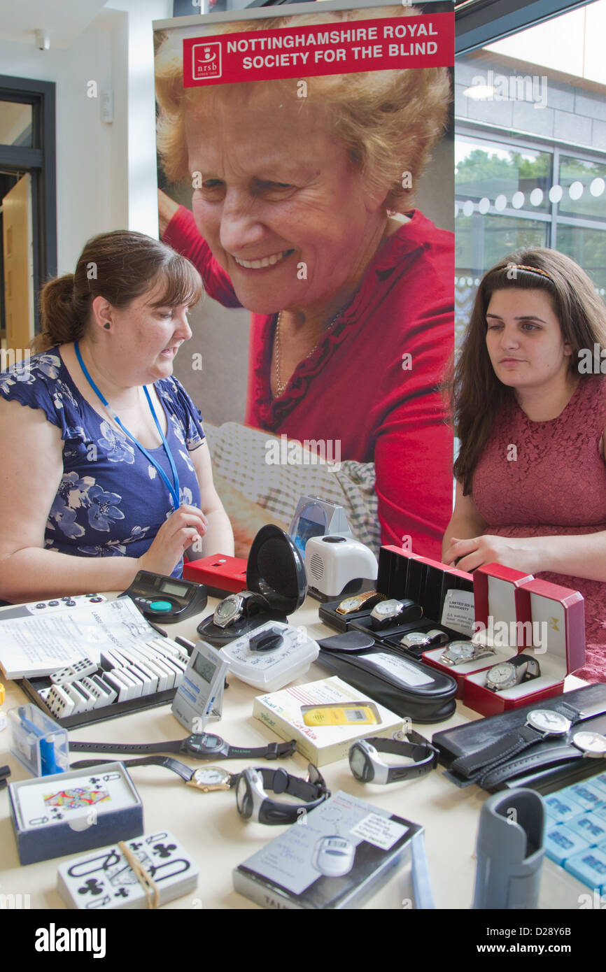 Out reach workers with stall of aids for visually impaired people Stock Photo