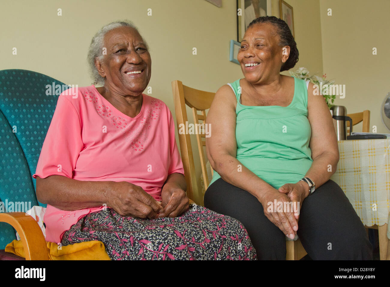Carer and elderly visually impaired woman laughing Stock Photo