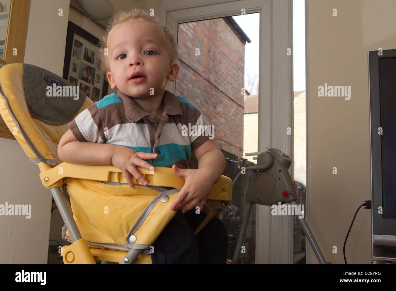 Toddler in high chair Stock Photo - Alamy
