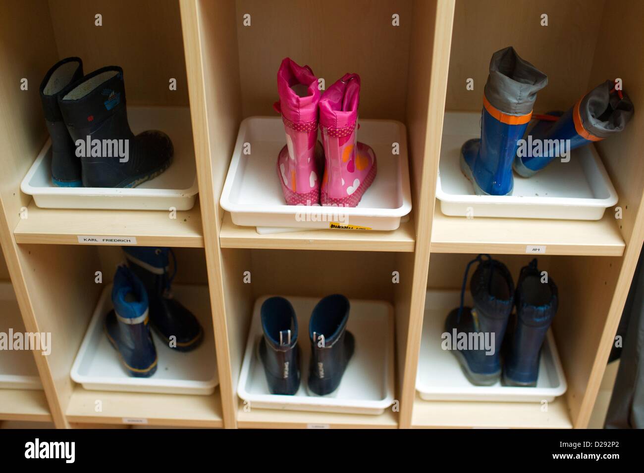 Children's rain boots stand in the shoe cabinet in the 24 hour nursery  'Nidulus' in Schwerin, Germany, 25 June 2012. The nursery is funded by the  local municipality and has been offering