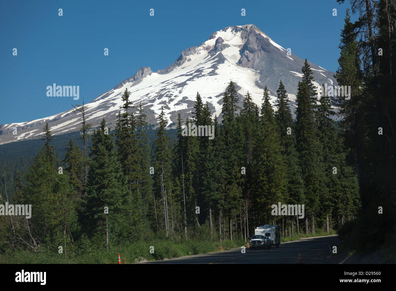 Caravan being towed on picturesque road near Government Camp, Oregon USA with beautiful senery including snowy mountains Stock Photo