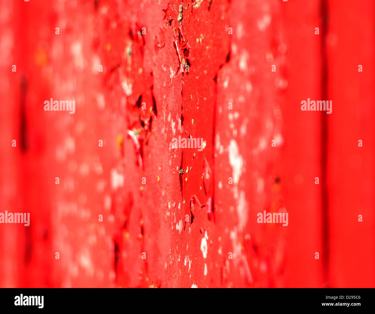 Flaking red paint on a traditional telephone phone box. Stock Photo