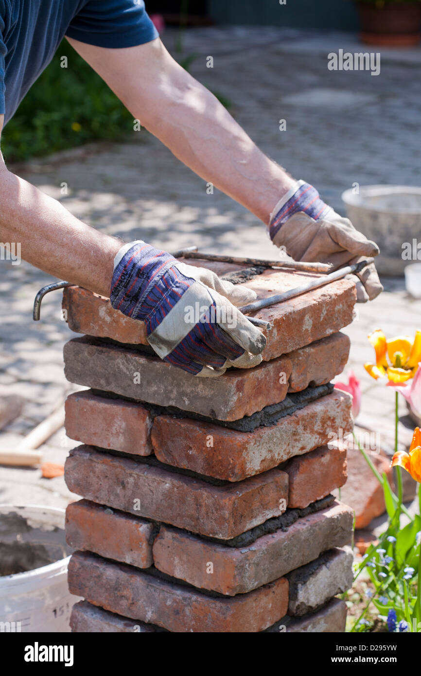 Building a brick pillar. Stock Photo