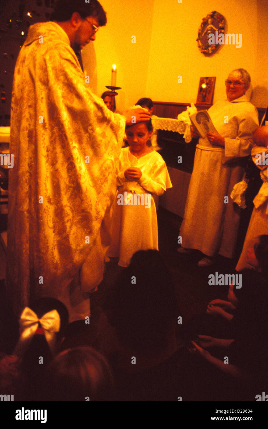 Priest Blessing 8 Year Old Girl At Her Baptism Stock Photo Alamy