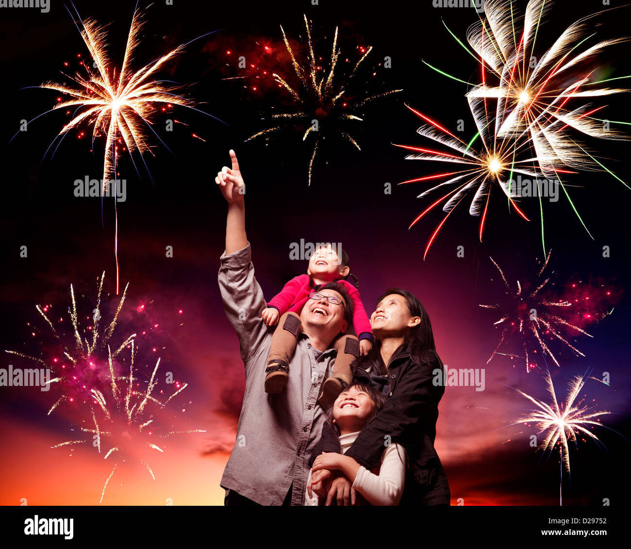 happy family looking fireworks in the evening sky Stock Photo - Alamy