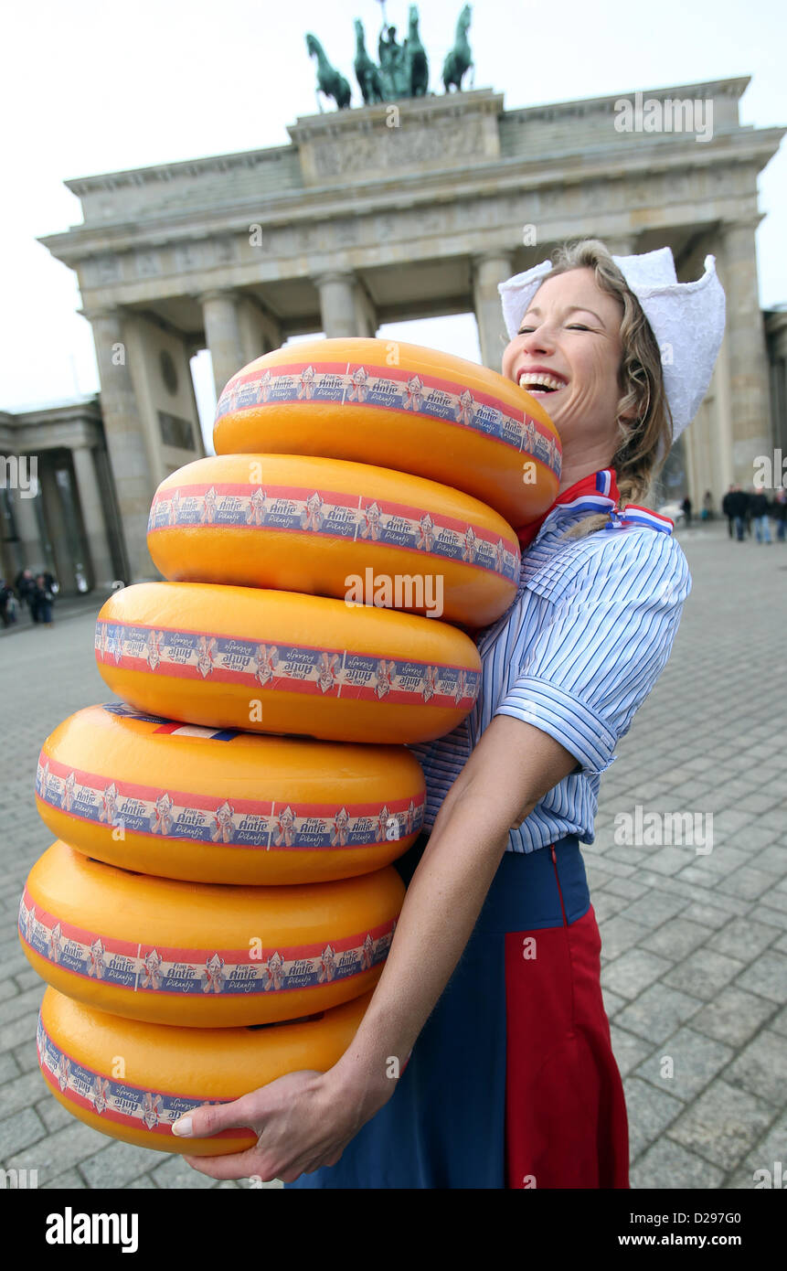 Dutch advertising character 'Frau Antje' carries cheese wheels for the Green Week agriculture trade fair at the Brandenburg Gate in Berlin, Germany, 17 January 2013. The Netherlands are partner country of the Green Week. The Green Week open doors to the public from 18 to 27 January. Photo: WOLFGANG KUMM Stock Photo