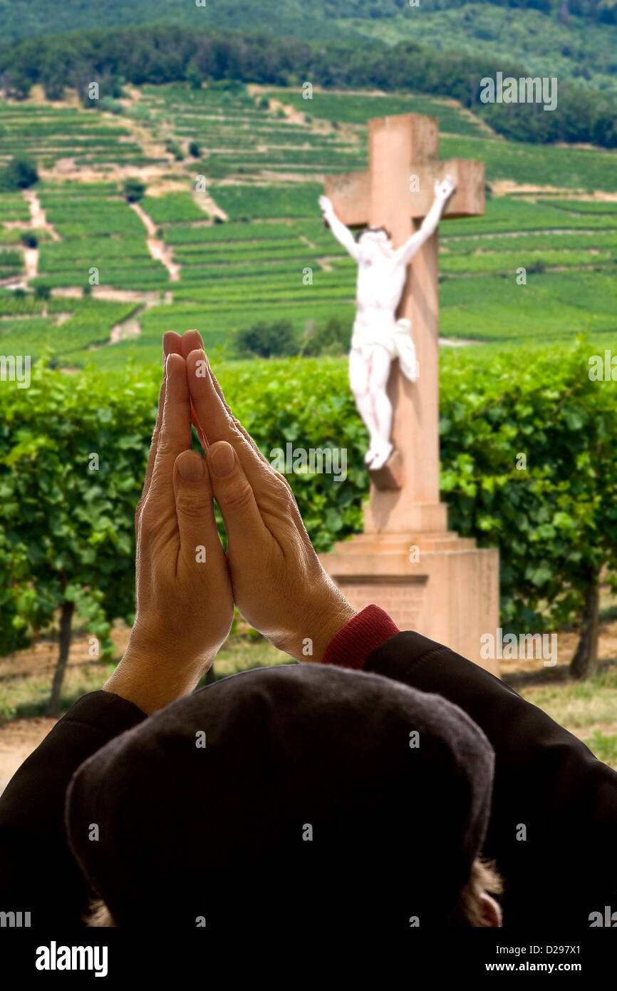 Man praying in front of Jesus crusi Stock Photo