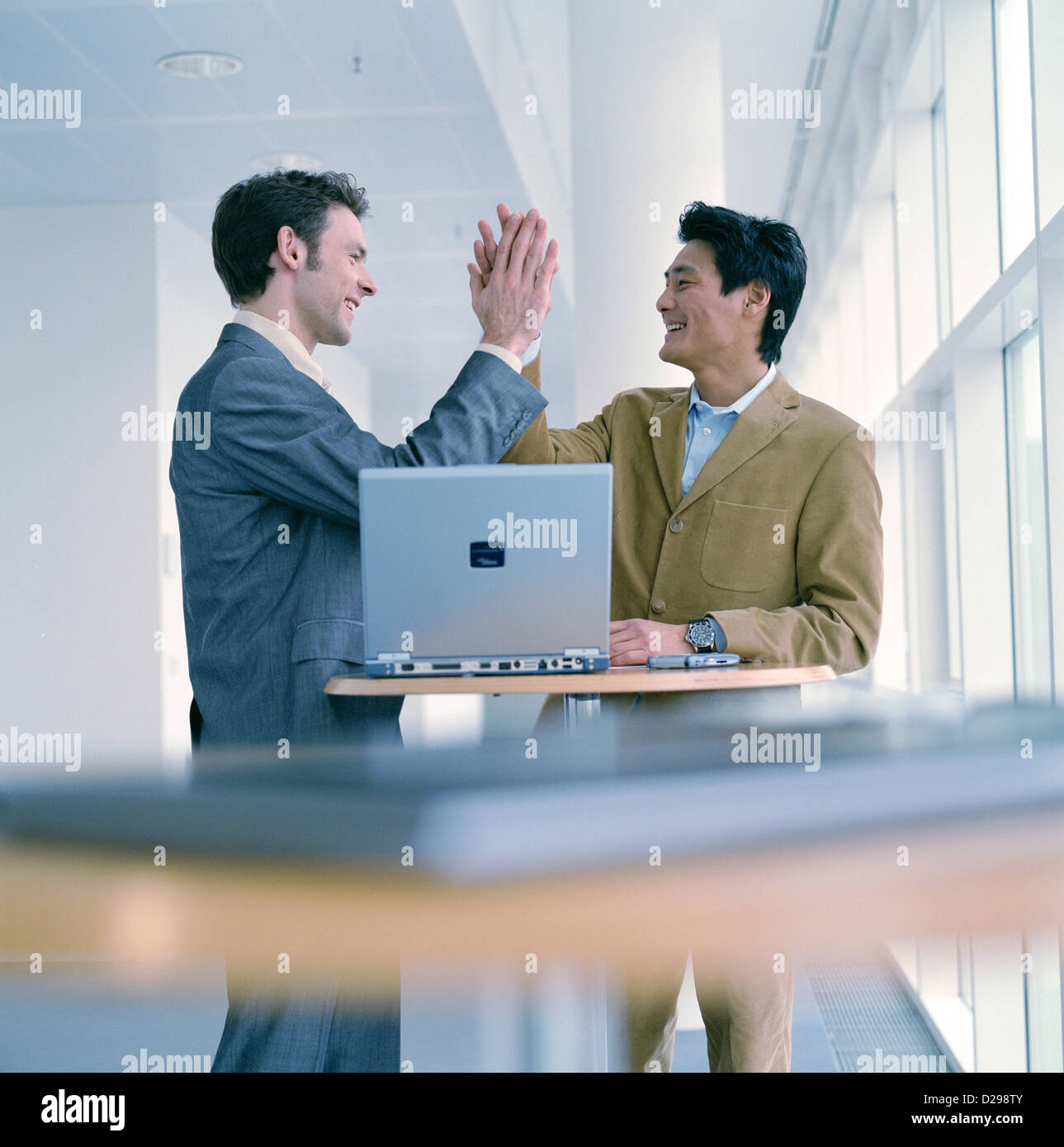 Two business people to give so a high five License free except ads and outdoor billboards Stock Photo